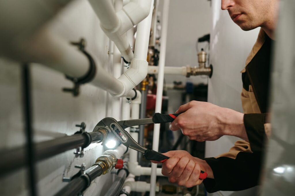 Plumbers maintaining commercial plumbing pipes in Prescott