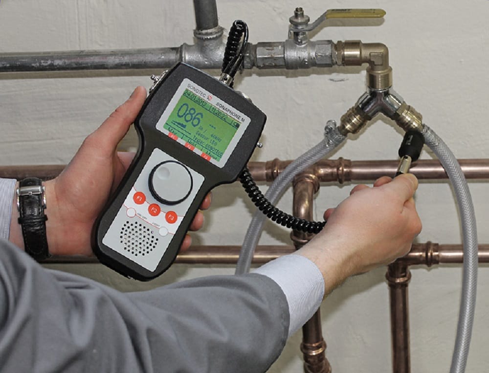 Plumber testing pipes with electronic leak detection equipment in Prescott