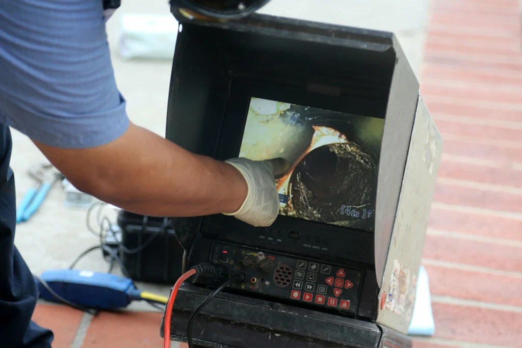 Technician viewing a drain inspection camera in Prescott