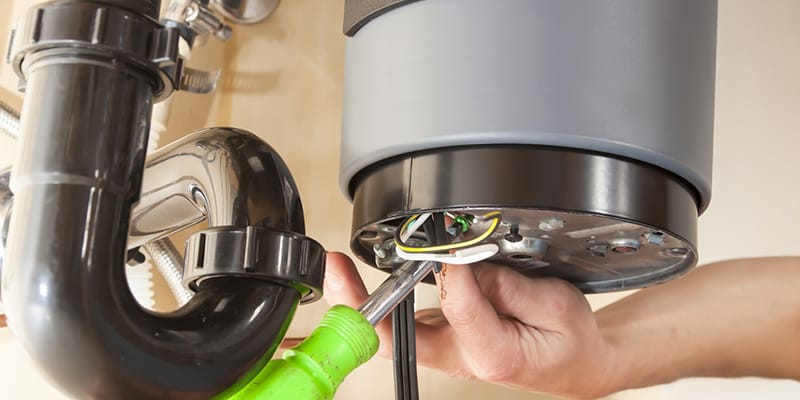Technician repairing the heating element of a water heater in Prescott