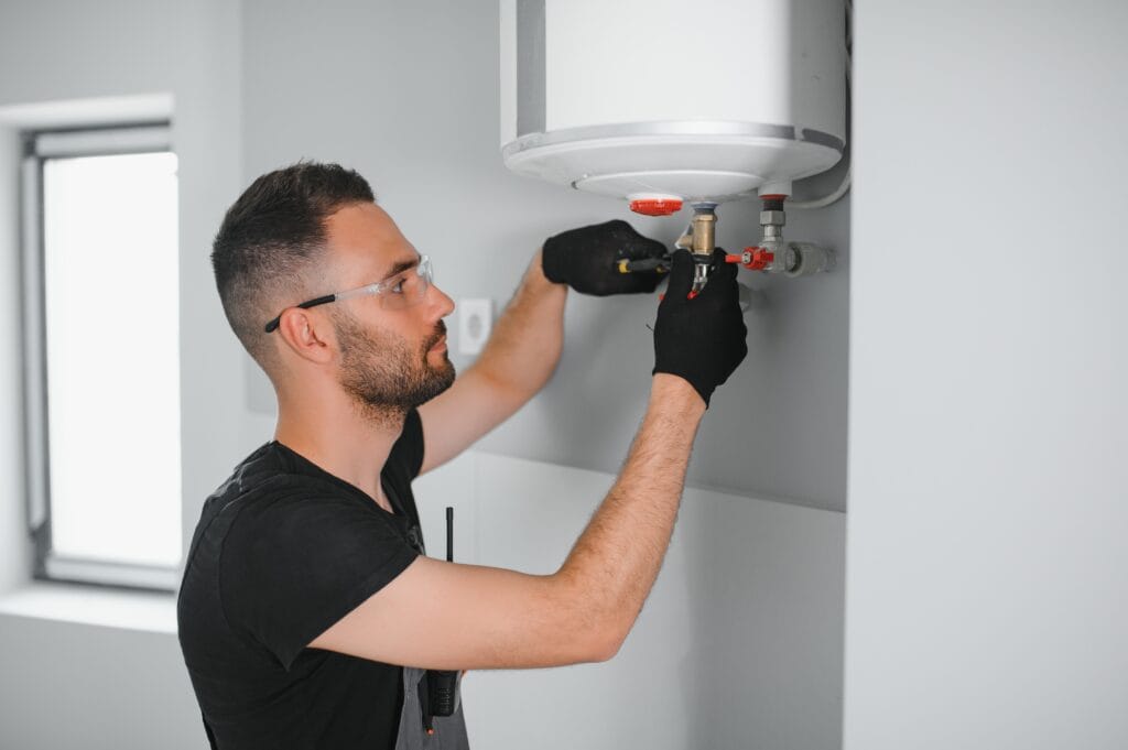 Technician performing water heater maintenance in Prescott