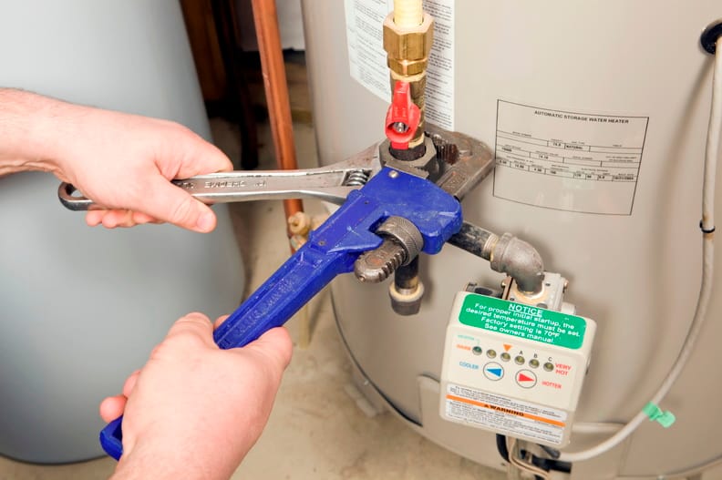 Plumber repairing a water heater valve in Prescott